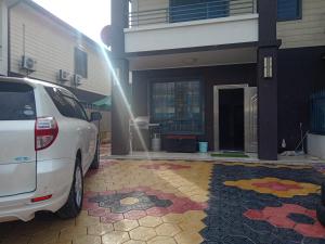 a white car parked in front of a house at Apartment in Port Moresby - Short Stays in Port Moresby