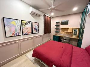 a bedroom with a red bed and a desk at The Celery Homestay @PPAM Saderi - Cozy&Homey in Putrajaya