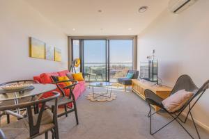 a living room with a couch and a table at Luxury 2 Bedroom CBD Apartment with Free Parking in Christchurch