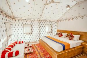 a bedroom with two beds and a couch at Desert Safari Camp & Resort Sam in Sām