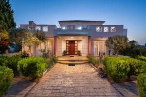 a house with a stone pathway in front of it at Villa Rea Luxury 5 bdrs with swimming pool in Kremasti