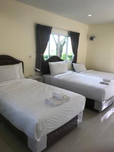 Postel nebo postele na pokoji v ubytování Sripiamsuk Resort Bangkok