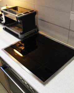 a black dish washer on a kitchen counter at AIOLOS VOULA near the sea apartment in Athens
