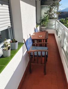 a balcony with a table and chairs on it at Vivienda Turístico Erreka Beach in Mundaka