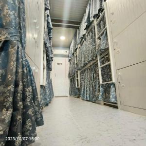 a long aisle with curtains in a store at Marol Metro Dormitory in Mumbai