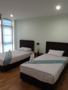 Postel nebo postele na pokoji v ubytování Sripiamsuk Resort Bangkok
