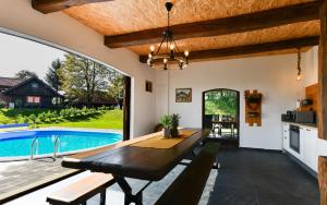 a dining room with a table and a pool at Holiday Home BIBA With Heated Outdoor Pool in Gornja Stubica +26 photos