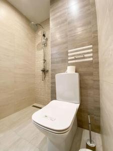 a bathroom with a white toilet in a room at Maryland Apartment in Sofia