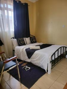 Postel nebo postele na pokoji v ubytování G&G Homes Eldoret