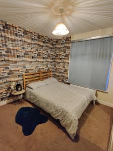 a bedroom with a bed and a projection screen at House with great location near Harry Potter studio in Watford