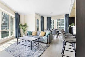 a living room with a couch and a table at StoneTree - Stylish 2BR with Dubai Marina Canal View in Dubai