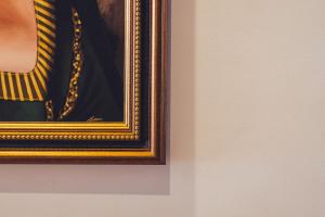 a framed picture of a woman wearing a yellow sweater at Apartamentos Islamar Arrecife in Arrecife