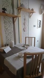 a dining room table with a white table cloth on it at Edelweiss in Valli del Pasubio