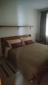 a bedroom with a large bed with two pillows at Edelweiss in Valli del Pasubio