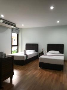 Postel nebo postele na pokoji v ubytování Sripiamsuk Resort Bangkok