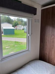 a bedroom with a window and a bed in front of it at Bird Lake Pastures in Great Billing