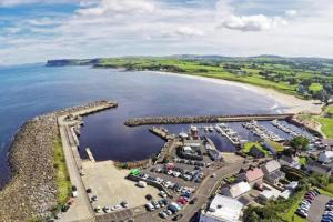 an aerial view of a harbor with a marina at Stay Indigo in Ballycastle