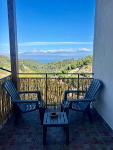 two chairs and a table on a balcony with a view at Marì in Vico del Gargano