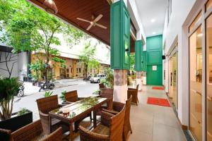 an outdoor dining area with a table and chairs at New Sunny 1 Hotel - Q7 by Bay Luxury in Ho Chi Minh City