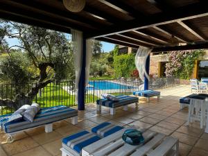 a patio with lounge chairs and a swimming pool at Casa Tapioles in Basella