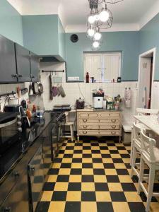 a kitchen with a checkered floor in a kitchen at SEA Villa Rosa Seaside & Garden. in Porto