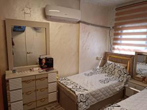 a bedroom with a bed and a dresser and a mirror at hostel ـ Karak dream in Kerak