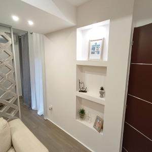 um quarto com paredes brancas e prateleiras brancas em Navarino Jacuzzi Studio RT Hospitality Services em Tessalônica
