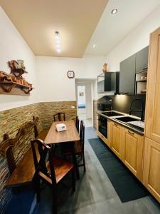 a kitchen with a wooden table and chairs in it at Prati di Borgo in Rome