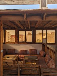 a living room with a couch and a table at darna surf house anza in Agadir