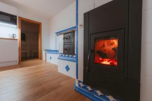 a living room with a fireplace in the wall at Chalupa U lesa in Vápenice