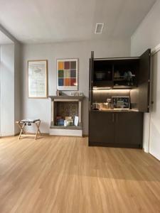 a living room with a wooden floor and a fireplace at Notte di Note - home hospitality in Busto Arsizio