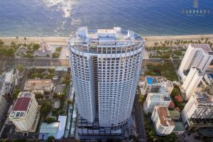 an aerial view of a tall building next to the beach at JK.Boutique Oceanfront Panorama Residence in Nha Trang