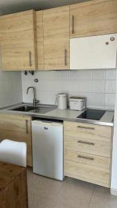 a kitchen with a sink and a dishwasher at El Cotillo On The Beach Playa La Concha Sea view in Cotillo