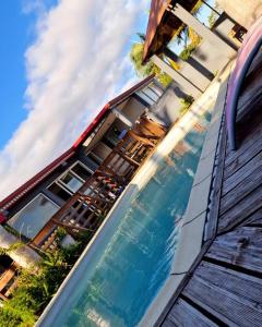 a swimming pool in front of a house at villa corossol in Petite Île