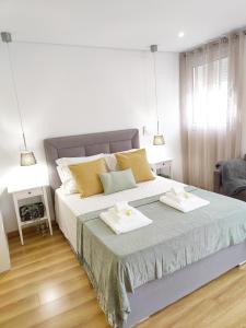 a bedroom with a large bed with two towels on it at Apartment in the historic center of Porto in Porto