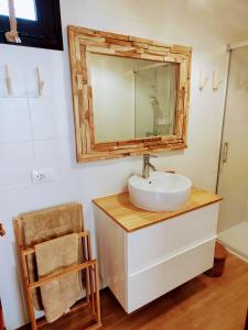 a bathroom with a sink and a mirror on the wall at El Cotillo On The Beach Playa La Concha Sea view in Cotillo