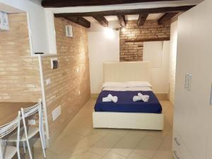 a bedroom with a bed with two towels on it at Venezia Holiday in Chioggia