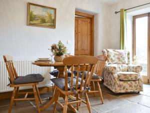 a dining room with a table and a chair at The Stable - Uk10271 in Appersett