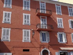 un edificio naranja con ventanas y balcones blancos en T3 colonella, en Bastia