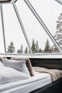 Voodi või voodid majutusasutuse Northern Lights Village Pyhä toas