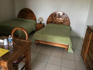 A bed or beds in a room at Hotel Colibri Queretaro