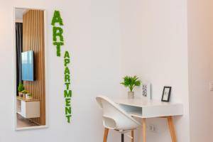 a white desk with a chair and a mirror at ART Apartment II in Târgu-Mureş