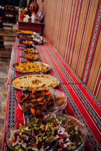 uma linha de buffet com muitos pratos de comida em Rum Under The Stars Camp em Wadi Rum