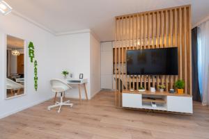 a living room with a flat screen tv on a wall at ART Apartment II in Târgu-Mureş