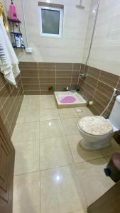 a bathroom with a toilet and a tiled floor at The Good choice 