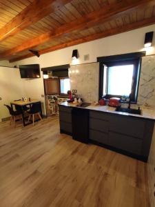 a large kitchen with a counter and a table at 27A01 Casa Uría - Cam. Santiago in Berducedo
