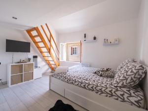 a bedroom with a bed and a television in it at Maison triplex 6 personnes près de Disney et Paris in Montévrain