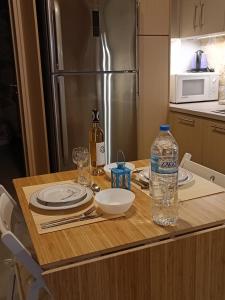 a kitchen with a table with a bottle of water on it at Villa VaKo in Vathí