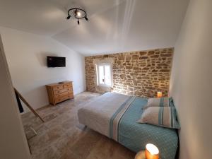 Posteľ alebo postele v izbe v ubytovaní Chez Véro chambres d'hôtes & Maison en pierre contemporaine