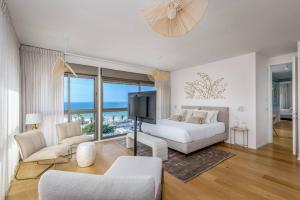 a bedroom with a bed and a tv in a room at #Breathtaking 4BR/3BA Duplex Seafront in Tel Aviv